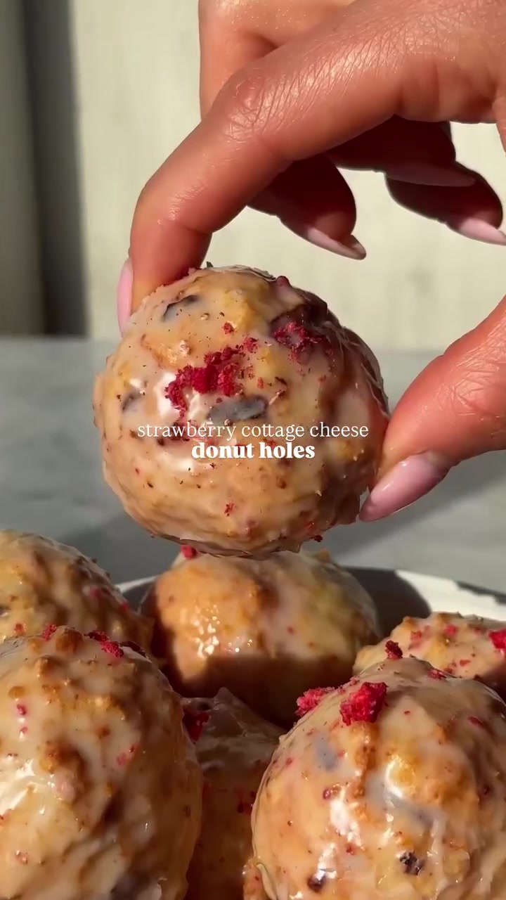 My cottage cheese donut holes but make them Valentine’s Day esque 🍓 these *strawberry cottage cheese donut holes* are perfectly fluffy and soft and pack 5 G protein each!

FULL RECIPE BELOW
Strawberry Cottage Cheese Donut Holes (makes 9)
Ingredients
* ¾ cup @good_culture 4% Cottage Cheese, just blended (make sure not to overblend or it will be too thin) 
* 1 cup flour (may need to 1-2+ tbsp additional flour)
* 1 egg 
* 1 tbsp maple syrup 
* Zest from 1 lemon 
* 2 tsp baking powder 
* ¼ tsp baking soda 
* ¼ tsp salt
* 1/3 cup lightly crushed freeze dried strawberries 
Icing 
* ½ cup powdered sugar
* ¼ tsp vanilla 
* 1-2 tbsp milk 
* 1 tsp blended freeze dried strawberries 

Directions
1. In a large mixing bowl, whisk together flour, lemon zest, baking powder, baking soda, and salt. Add the blended Good Culture cottage cheese, egg, and maple syrup and stir well with a spoon. Once it starts to come together, fold in freeze dried strawberries. *it’s important you do NOT blend the wet ingredients separate than the dry for optimal texture or else it may be too soft of a dough*

2. Take ~1.5 tbsp dough at a time and carefully roll into balls. Flour hands if needed. 

3. Preheat air fryer, coating the basket with non-stick cooking spray.

4. Place balls in air fryer, trying not to overcrowd the basket. Spray with non-stick cooking spray. Air fry for 6-7 minutes at 350F.

5. Remove from air fryer and cool. While donuts are cooling, whisk together the ingredients for the icing.

6. Once donuts are cooled completely, dip them in the glaze and let set for ~10-15 minutes. Enjoy!

#cottagecheesedonutholes #donutholes #valentinesdaydessert #airfryer