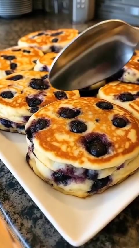 Mediterranean Blueberry Pancakes"

Ingredients:

- 1 cup whole‑wheat flour (or almond flour)
- 1 tsp baking powder
- Pinch of salt
- 2 eggs
- ¾ cup Greek yogurt mixed with ¼ cup water
- 2 tbsp honey (optional)
- 2 tbsp extra‑virgin olive oil (for batter & cooking)
- 1 cup fresh blueberries
- ½ tsp vanilla extract (optional)

Method:

1. Mix flour, baking powder, and salt.
2. Whisk eggs, yogurt‑water mix, honey, 1 tbsp olive oil, and vanilla.
3. Combine wet & dry mixtures into a smooth batter.
4. Fold in blueberries.
5. Heat a non‑stick pan with 1 tbsp olive oil, pour ~¼ cup batter per pancake.
6. Cook 2–3 min until bubbles appear, flip & brown the other side.
7. Serve stacked with golden‑brown, fluffy appearance.